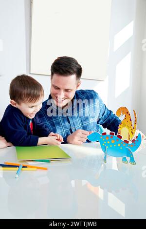 Father and son enjoying craft time together Stock Photo