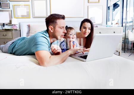 Family using a laptop together at home Stock Photo