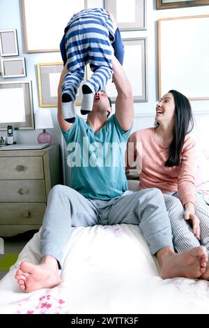 Family playing on a bed. Stock Photo
