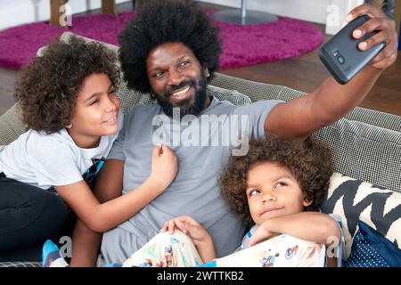 Family taking a selfie on a couch Stock Photo