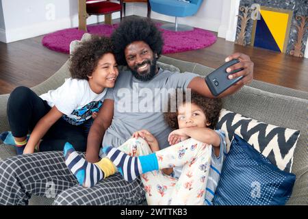 Family taking a selfie on the couch Stock Photo