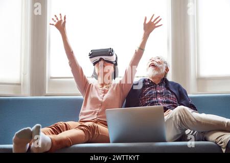 Elderly man and woman having fun with VR headset Stock Photo