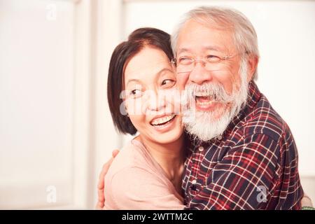 Elderly couple embracing and smiling Stock Photo
