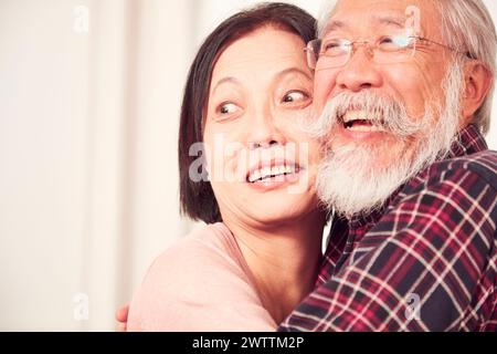 Elderly couple embracing and smiling Stock Photo