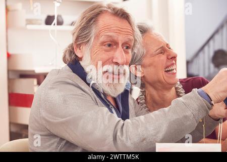 Senior couple laughing together indoors Stock Photo