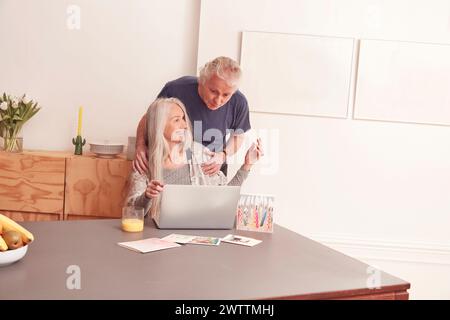 Elderly couple using a laptop at home Stock Photo