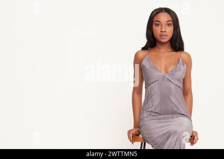 Woman posing in a grey dress Stock Photo