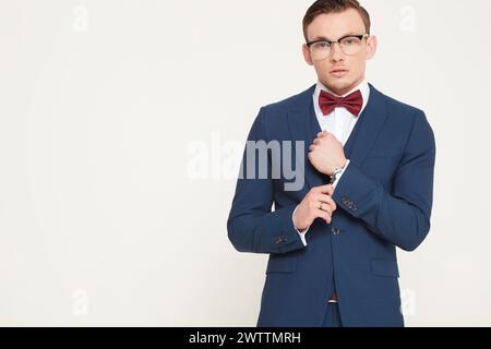 Man in blue suit with red bow tie Stock Photo