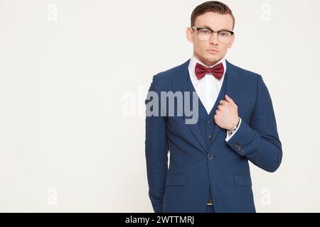 Man in a blue suit and red bow tie Stock Photo