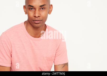 Man in pink t-shirt posing for portrait Stock Photo
