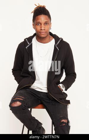 Young man posing in casual black attire. Stock Photo