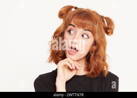 Woman with surprised expression and double buns hairstyle Stock Photo