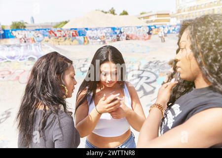 Three women engaging in conversation outdoors. Stock Photo