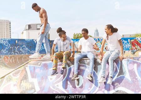 Group of friends on graffiti-covered rooftop Stock Photo