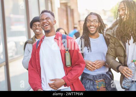 Group of happy young friends laughing on a city street Stock Photo