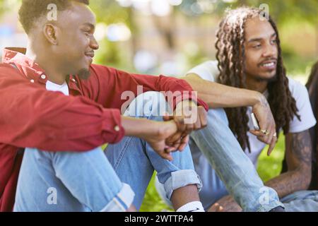 Two men smiling and sitting outdoors Stock Photo