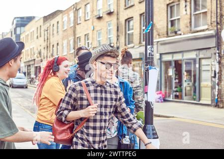 Group of young adults walking in an urban street Stock Photo