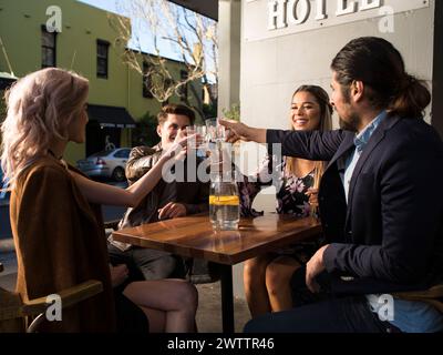 Friends toasting at an outdoor table Stock Photo