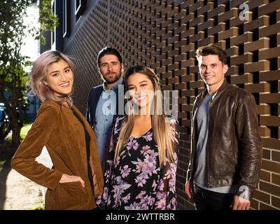 Four friends posing together outdoors Stock Photo