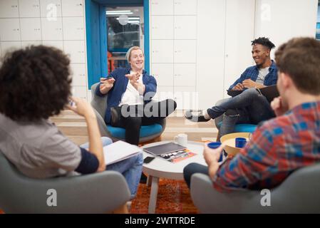 Colleagues having a relaxed meeting in a modern office Stock Photo