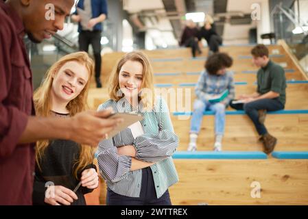 Group of people using a smartphone together on steps Stock Photo