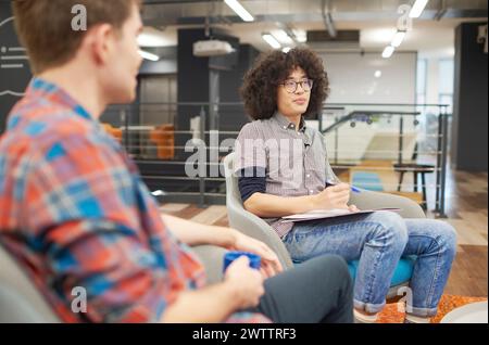 Colleagues in a casual office meeting. Stock Photo