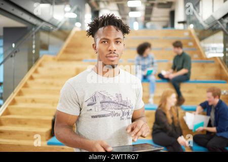 Man standing in front of steps in a modern office space Stock Photo