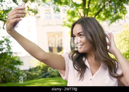 Woman taking a selfie outdoors Stock Photo