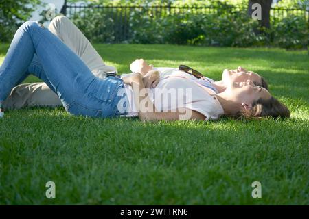 Two people relaxing on grass Stock Photo