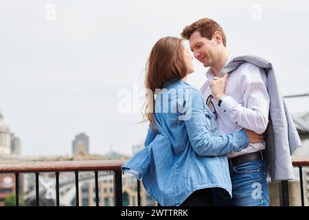 Couple embracing on a bridge Stock Photo