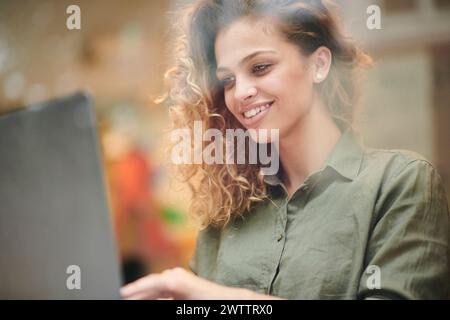 Smiling woman using a laptop Stock Photo