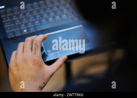 Close-up of a hand on a laptop trackpad Stock Photo