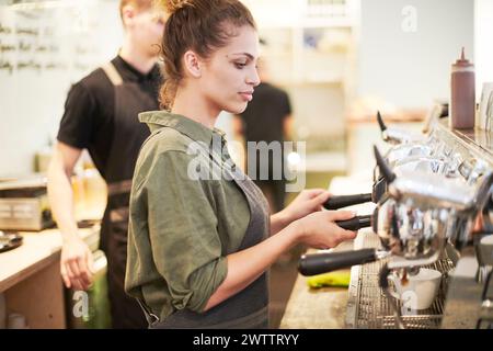 Barista operating an espresso machine Stock Photo
