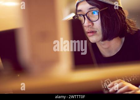 Young person focused on computer work Stock Photo