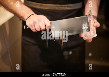 Chef holding a large kitchen knife Stock Photo