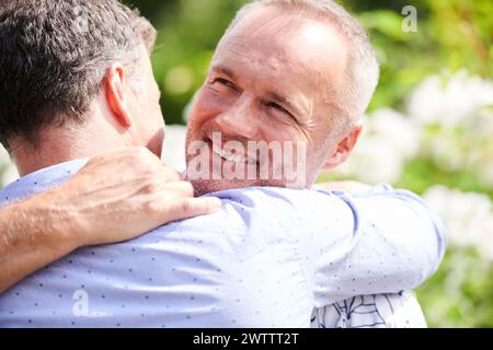Two men embracing with smiles Stock Photo