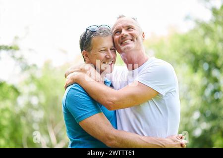 Two men hugging and smiling outdoors Stock Photo