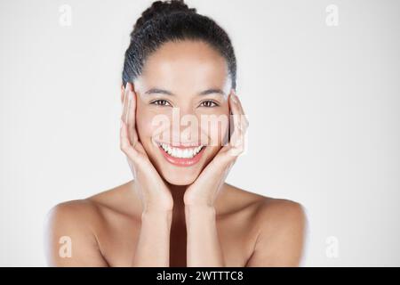 Smiling woman holding her face with both hands Stock Photo