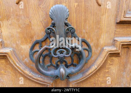 European Vintage old metal wrought iron door knocker. Design detail. Paris.France Stock Photo