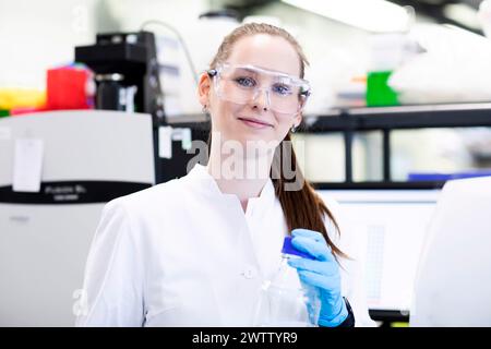 Confident scientist working in a lab with equipment Stock Photo