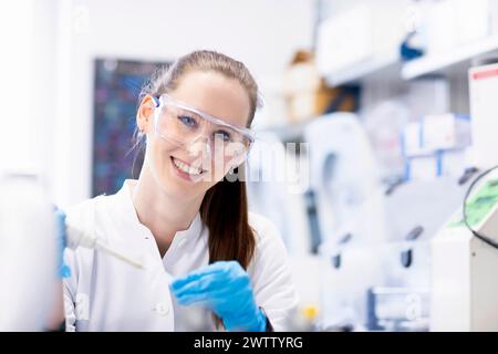 Female scientist working with a pipette in a laboratory. Stock Photo