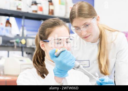 Two scientists analyzing a sample in a lab Stock Photo