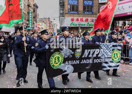 New York, Chinatown, USA - February 12, 2023: NYPD Asian Jade Society parading in front of the public during the Chinatown Chinese New Year 2023 celeb Stock Photo