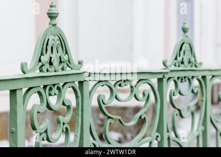 Decoration design elements of an outdoor vintage green forged railings, close up photo with selective soft focus Stock Photo