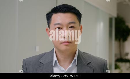 Portrait serious calm Asian ethnic man business employer peaceful Korean businessman Chinese male Japanese middle-aged guy at office hallway confident Stock Photo