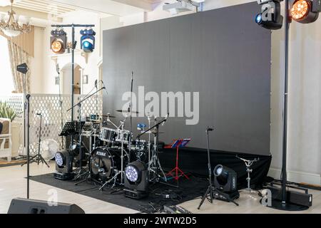 a Live music stage setup with drum set and professional lighting, ready for performance Stock Photo