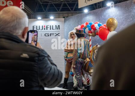 Birmingham, England, UK. Tuesday 19th March 2024. Models at the Fujifilm stand. Credit: Lu Parrott/Alamy Live News Stock Photo