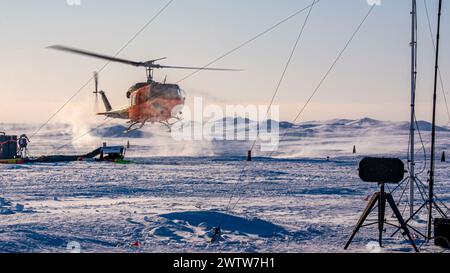 240315-N-EI510-1054 BEAUFORT SEA, Arctic Circle (March 16, 2024) – A Bell UH-1H helicopter lands at Ice Camp Whale during Operation Ice Camp (ICE CAMP) 2024. ICE CAMP is a three-week operation that allows the Navy to assess its operational readiness in the Arctic, increase experience in the region, advance understanding of the Arctic environment, and continue to develop relationships with other services, allies, and partner organizations. (U.S. Navy photo by Mass Communication Specialist 1st Class Scott Barnes) Stock Photo