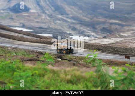 mining truck in an open pit at coal mining or quarry Stock Photo