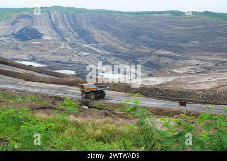 mining truck in an open pit at coal mining or quarry Stock Photo